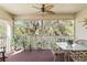 Cozy screened patio offering beautiful views of lush greenery, ideal for outdoor relaxation and dining at 306 Lynbrook Cir # 201, Venice, FL 34292