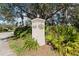 Entrance sign for Waterside Village with lush tropical foliage at 306 Lynbrook Cir # 201, Venice, FL 34292