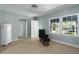 Bright and open living room with light floors, white trim, and large windows at 3200 Avenue A W, Bradenton, FL 34205