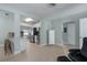 Open concept living space with light colored flooring, an accent cabinet, and lots of natural light at 3200 Avenue A W, Bradenton, FL 34205