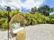 Tropical backyard retreat featuring a unique hanging chair and lush greenery at 3228 Webber St, Sarasota, FL 34239