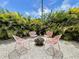 Cozy backyard seating area with comfortable chairs and a tranquil, tropical ambiance at 3228 Webber St, Sarasota, FL 34239