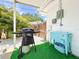 Outdoor grilling area with a lush tropical background and unique turquoise cooler at 3228 Webber St, Sarasota, FL 34239