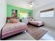 Charming bedroom featuring two beds, vintage rug, and bright, cheerful decor at 3228 Webber St, Sarasota, FL 34239