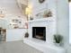 Stylish fireplace with white brick surround, complemented by modern decor and terrazzo flooring at 3228 Webber St, Sarasota, FL 34239