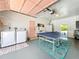 Organized garage area featuring laundry machines, a ping pong table, and plenty of storage at 3228 Webber St, Sarasota, FL 34239