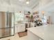 Well-lit kitchen with stainless steel appliances, white cabinetry, and a view of the dining area at 3228 Webber St, Sarasota, FL 34239