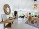Open-concept living and dining area with stylish decor, abundant natural light, and terrazzo flooring at 3228 Webber St, Sarasota, FL 34239