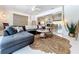 Open living room with stylish seating, modern decor, and a view of the adjacent dining area at 3228 Webber St, Sarasota, FL 34239