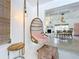Living room with hanging chair, modern decor, and an open view of the dining area at 3228 Webber St, Sarasota, FL 34239