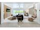 Spacious living room with comfortable seating, a ceiling fan, and sliding glass doors to the outdoor pool area at 3228 Webber St, Sarasota, FL 34239