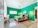 The main bedroom is bright and features a tropical theme, a ceiling fan, and a comfortable bed at 3228 Webber St, Sarasota, FL 34239