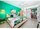 Colorful bedroom with a tropical theme, ensuite bathroom, and a modern ceiling fan at 3228 Webber St, Sarasota, FL 34239