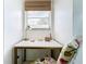 Bright office nook featuring a white desk, gold accents, and a window with natural light at 3228 Webber St, Sarasota, FL 34239