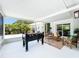 Covered patio featuring a foosball table, comfortable seating, and views of the backyard at 3228 Webber St, Sarasota, FL 34239