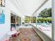 Inviting covered patio area with lounge chairs overlooking a refreshing pool and lush greenery at 3228 Webber St, Sarasota, FL 34239
