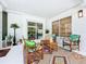 Relaxing enclosed patio with bright furniture, decorative rug, and ample natural light at 3228 Webber St, Sarasota, FL 34239
