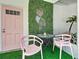 Charming patio space with a decorative flamingo light and bright pink accents at 3228 Webber St, Sarasota, FL 34239