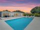 Gorgeous pool area with lounge seating, sunroom, and meticulously maintained surroundings at 3228 Webber St, Sarasota, FL 34239