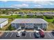 Exterior view of the condo building with well-maintained landscaping, parking and stairways at 3310 Loveland Blvd # 906, Punta Gorda, FL 33980