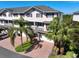 Charming townhome boasts a brick driveway, attached garage, and beautiful palm trees at 3316 10Th W Ln, Palmetto, FL 34221