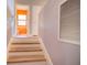 Hallway with wood stairs leading up to a brightly lit room with orange walls at 3316 10Th W Ln, Palmetto, FL 34221