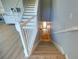 Staircase with light hardwood treads and white risers and railings at 3316 10Th W Ln, Palmetto, FL 34221