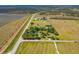 An aerial view of the property showcasing the surrounding land and landscaping at 34200 State Road 62, Parrish, FL 34219