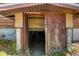 Exterior view of basement entrance with concrete foundation and weathered wood doors at 34200 State Road 62, Parrish, FL 34219