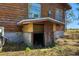 Exterior view of basement entrance with concrete foundation and weathered wood siding at 34200 State Road 62, Parrish, FL 34219