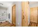 Hallway with a shower, wooden doors and a sliding barn door at 34200 State Road 62, Parrish, FL 34219