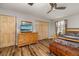 Bedroom with hardwood floors, a ceiling fan, and a window letting in natural light at 34200 State Road 62, Parrish, FL 34219