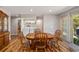 Dining area showing wood floors, dining table and chairs, washer and dryer hookups, and sliding glass door at 34200 State Road 62, Parrish, FL 34219
