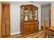 Dining area featuring wood floors, a wooden table, chair, and a decorative hutch and wood closet at 34200 State Road 62, Parrish, FL 34219
