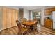 Eat-in dining area featuring wood floors, table and chair set, storage cabinets and sliding glass door at 34200 State Road 62, Parrish, FL 34219
