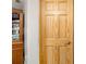 Interior view of a solid wood door with detailed paneling, complemented by a classic wooden cabinet at 34200 State Road 62, Parrish, FL 34219