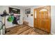An entryway featuring wood floors, a wooden bench, and wall decor next to a wooden front door at 34200 State Road 62, Parrish, FL 34219