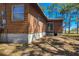 Home exterior features wood siding with large window and foundation at 34200 State Road 62, Parrish, FL 34219