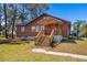View of the home with a wooden porch and stairs at 34200 State Road 62, Parrish, FL 34219