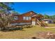View of the home with a wooden porch and stairs at 34200 State Road 62, Parrish, FL 34219