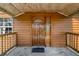 A wooden front door with glass panel and a 