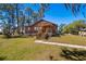 Charming home featuring a lush front yard and classic wooden porch at 34200 State Road 62, Parrish, FL 34219
