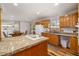Well-lit kitchen featuring a cooktop island, wooden cabinets, and modern design at 34200 State Road 62, Parrish, FL 34219