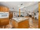 Kitchen featuring island with granite countertops, wood cabinets and hardwood floors at 34200 State Road 62, Parrish, FL 34219