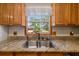 Stainless steel double sink with granite countertops and a window overlooking the outdoors at 34200 State Road 62, Parrish, FL 34219