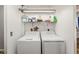 Laundry Room with white washer and dryer, wire shelving above, and overhead lighting at 34200 State Road 62, Parrish, FL 34219