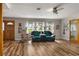 A bright living room with wood flooring, natural light from the windows, and comfortable seating at 34200 State Road 62, Parrish, FL 34219
