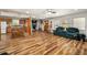 Open concept living room, connected to the kitchen, featuring new wood floors and lots of natural light at 34200 State Road 62, Parrish, FL 34219