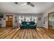Spacious living room featuring new wood flooring, comfortable furniture, and three large windows at 34200 State Road 62, Parrish, FL 34219