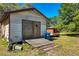 Exterior of shed building with double-door and a sloped wooden ramp in grassy yard at 34200 State Road 62, Parrish, FL 34219